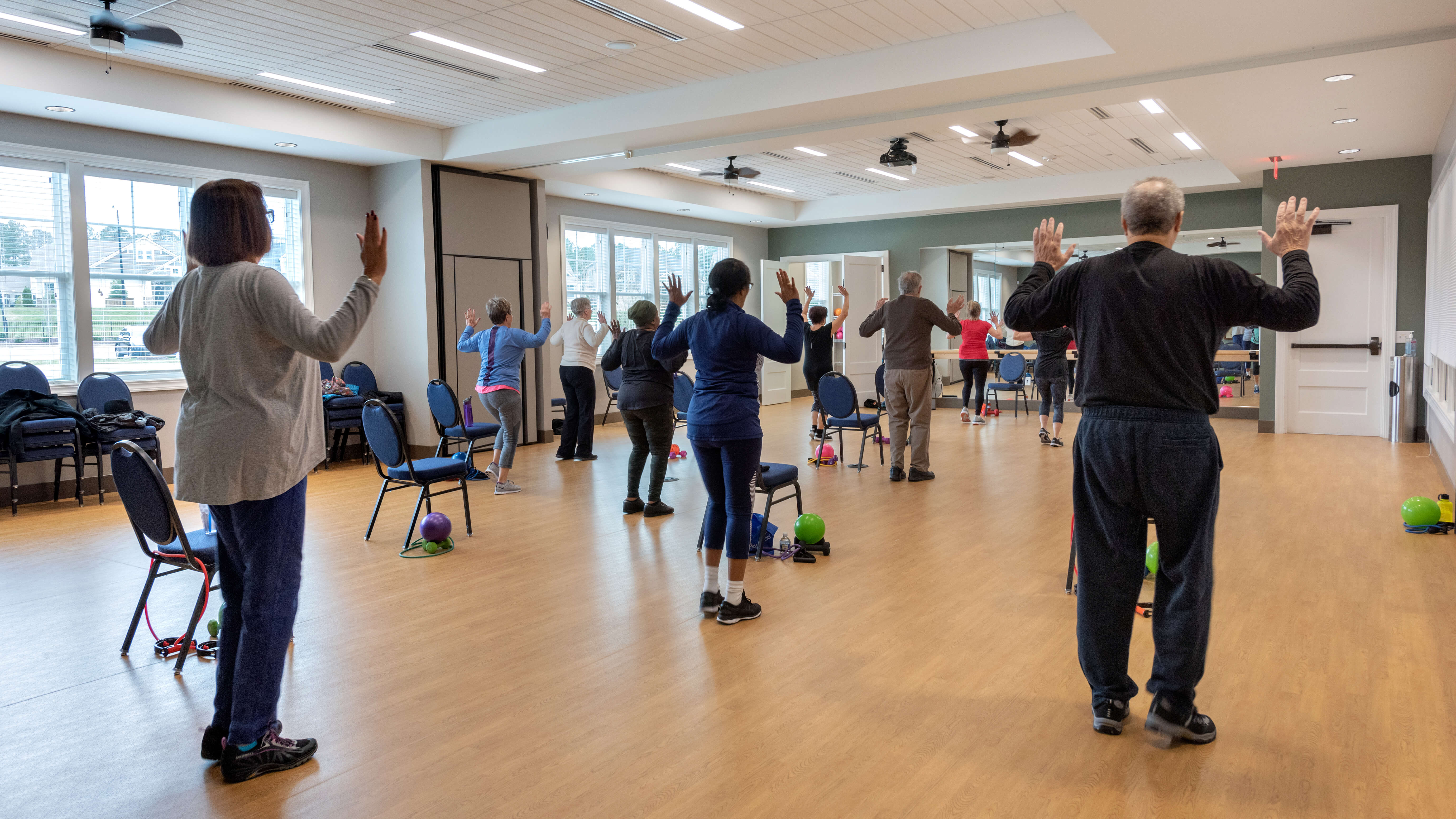 Residents of Creekside at Bethpage in Durham, NC attend a class at the aerobics and yoga studio