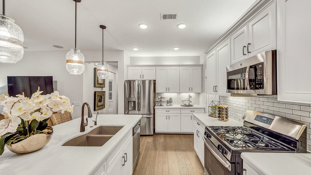 Photo: All white kitchen with stainless steal appliances. 