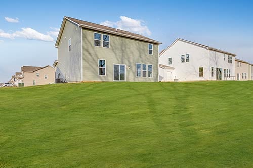 Two-story corner-lot home with 3–6 bedroom options and open yard, perfect for families in Camby, Indiana