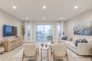 Spacious and modern living room in Midtown model with patio doors, ample lighting, and contemporary design