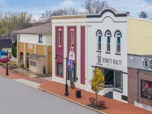 Streetscape of Mooresville’s downtown area featuring local real estate offices and historic charm