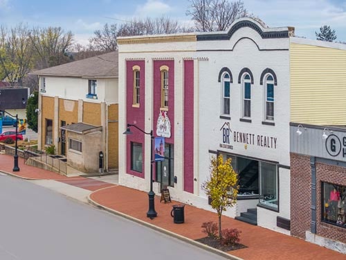 Streetscape of Mooresville’s downtown area featuring local real estate offices and historic charm